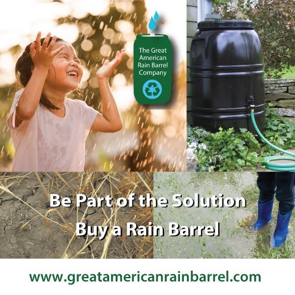 Picture of a young girl in the rain standing by a rain barrel